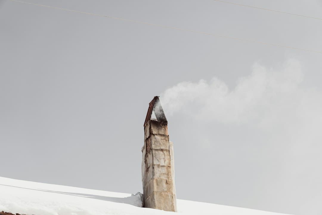 smoke coming out of a chimney on top of a building